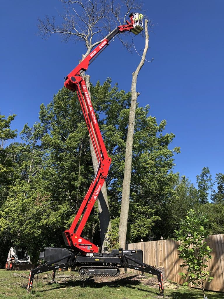 JRC Outdoor Services crew performing professional tree removal with aerial lift in Lake Orion Michigan